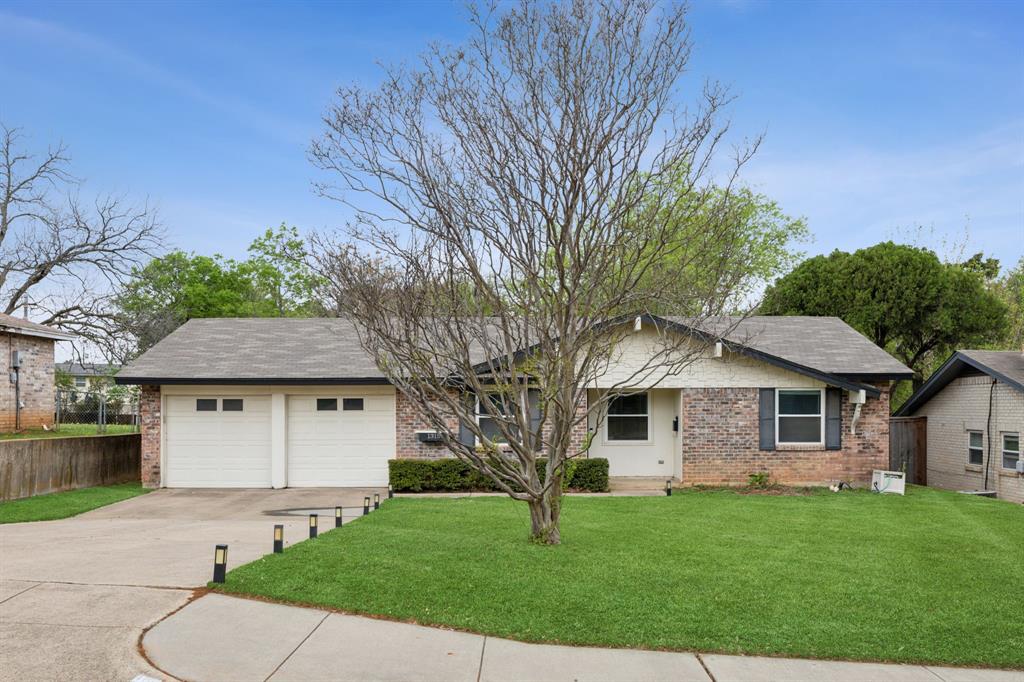 a front view of a house with a garden and yard