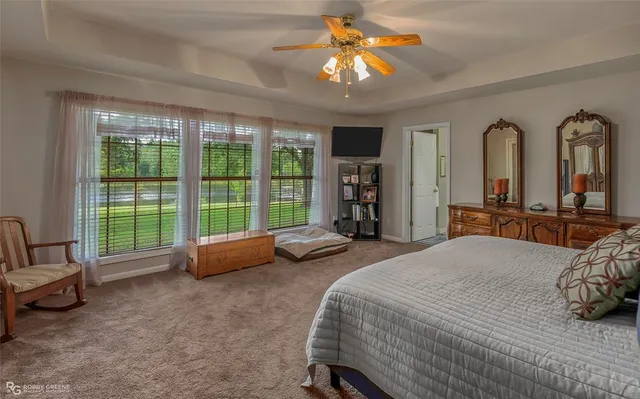 a bedroom with bed and a large window