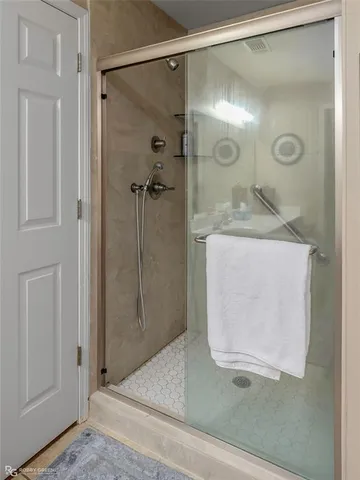 a bathroom with a glass shower door and a sink