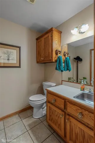 a bathroom with a sink a toilet and mirror
