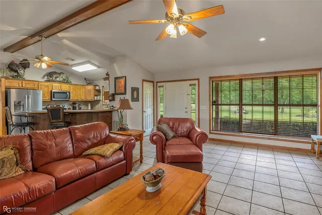 a living room with furniture and a floor to ceiling window