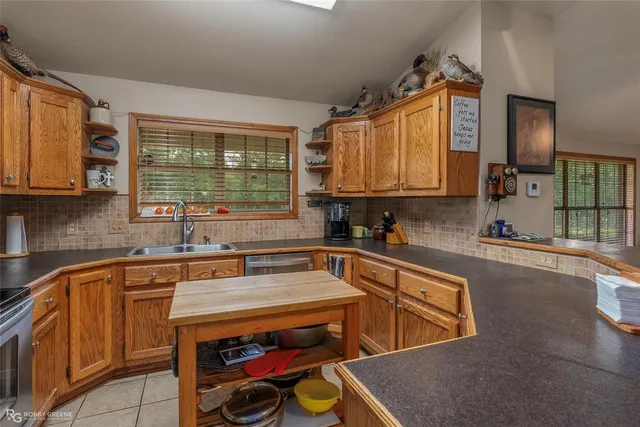 a kitchen with wooden cabinets and a sink