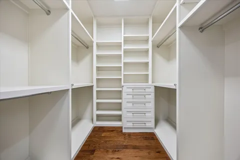 a view of walk in closet with empty racks