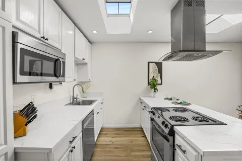 a kitchen that has a sink and a stove