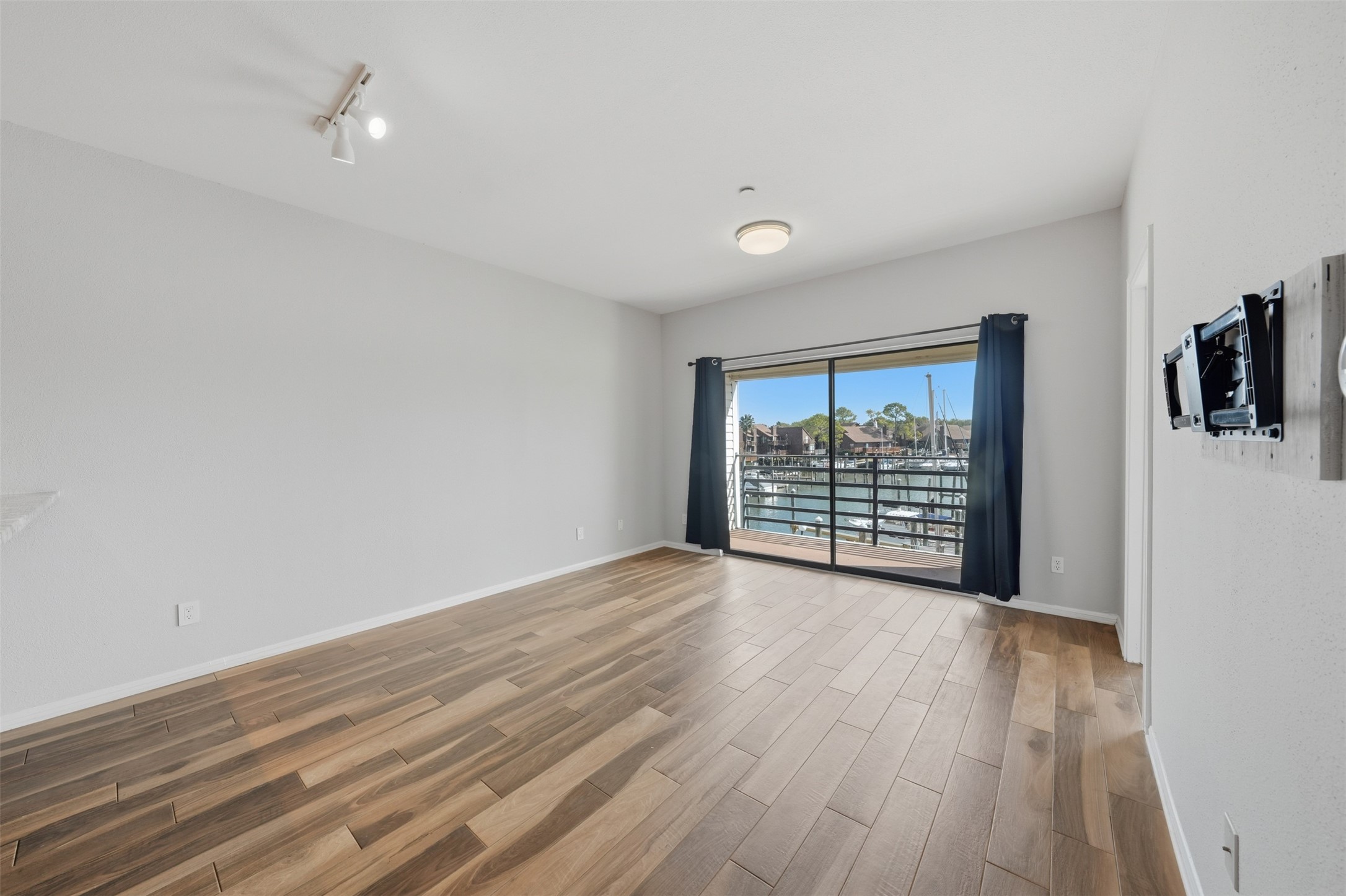 793 Davis Road, Unit 116 League City, TX 77573 - Photo 12 of 31 wooden floor in an empty room with a window