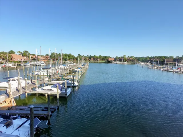 a view of a lake with a table and chairs