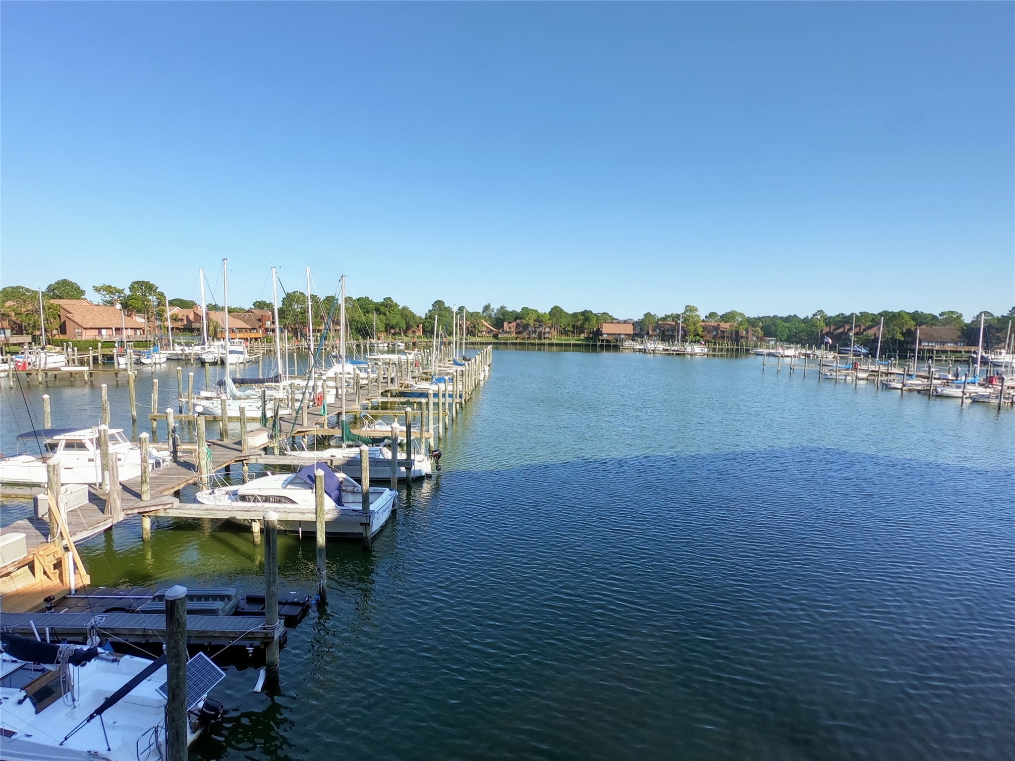 793 Davis Road, Unit 116 League City, TX 77573 - Photo 13 of 31 a view of a lake with a table and chairs