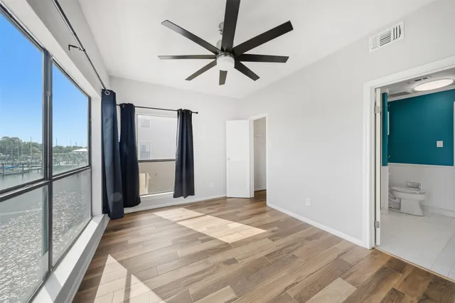 a view of a livingroom with a ceiling fan and window
