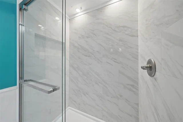 a bathroom with a glass shower door