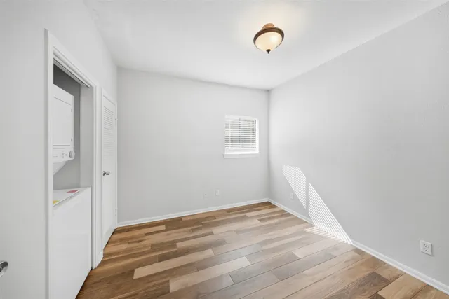 a view of a room with wooden floor and fan