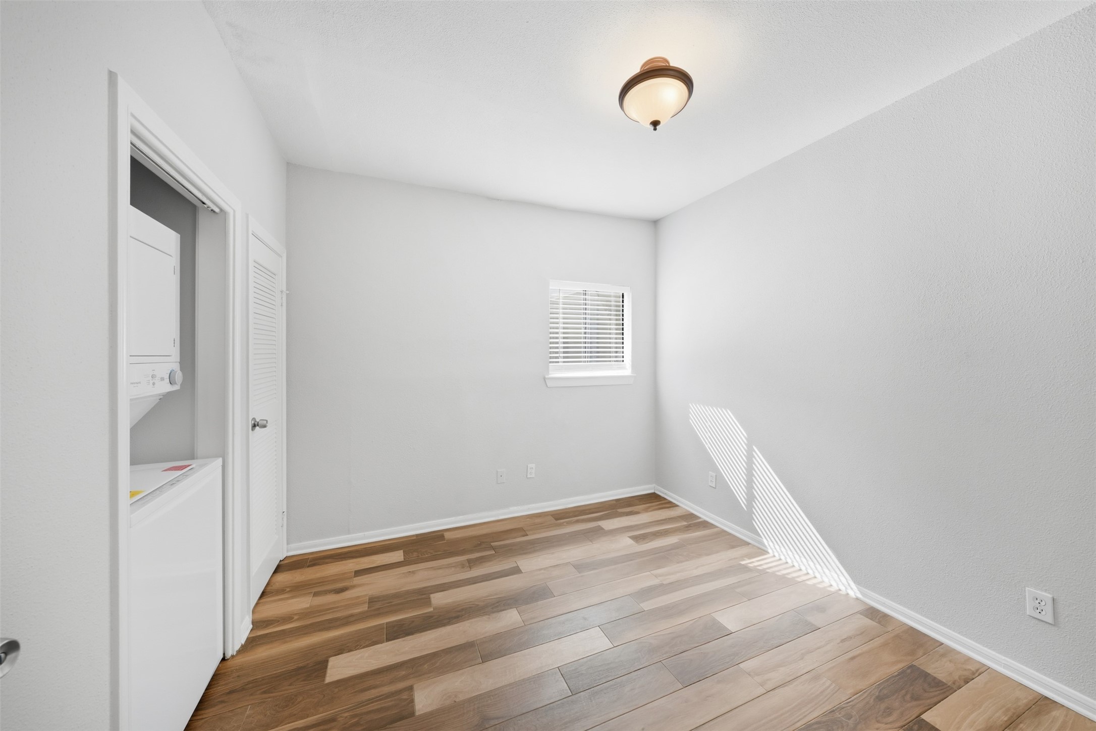 793 Davis Road, Unit 116 League City, TX 77573 - Photo 25 of 31 a view of a room with wooden floor and fan