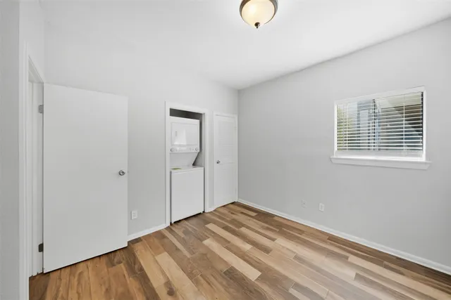 a view of a room with wooden floor and bathroom