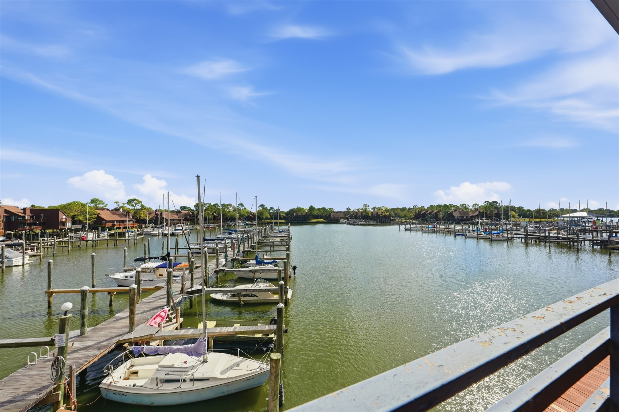 793 Davis Road, Unit 116 League City, TX 77573 - Photo 28 of 31 a view of a lake with a table and chairs in front of it