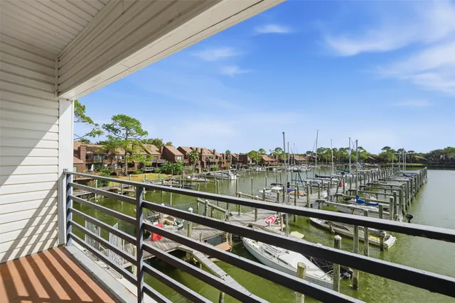 a view of a balcony with wooden floor and city view