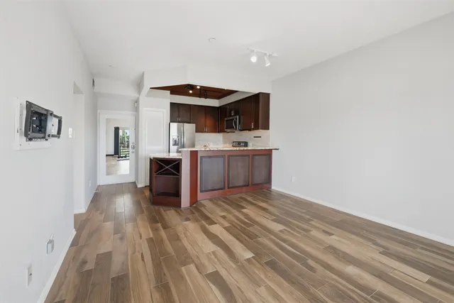 a view of kitchen with sink microwave and refrigerator