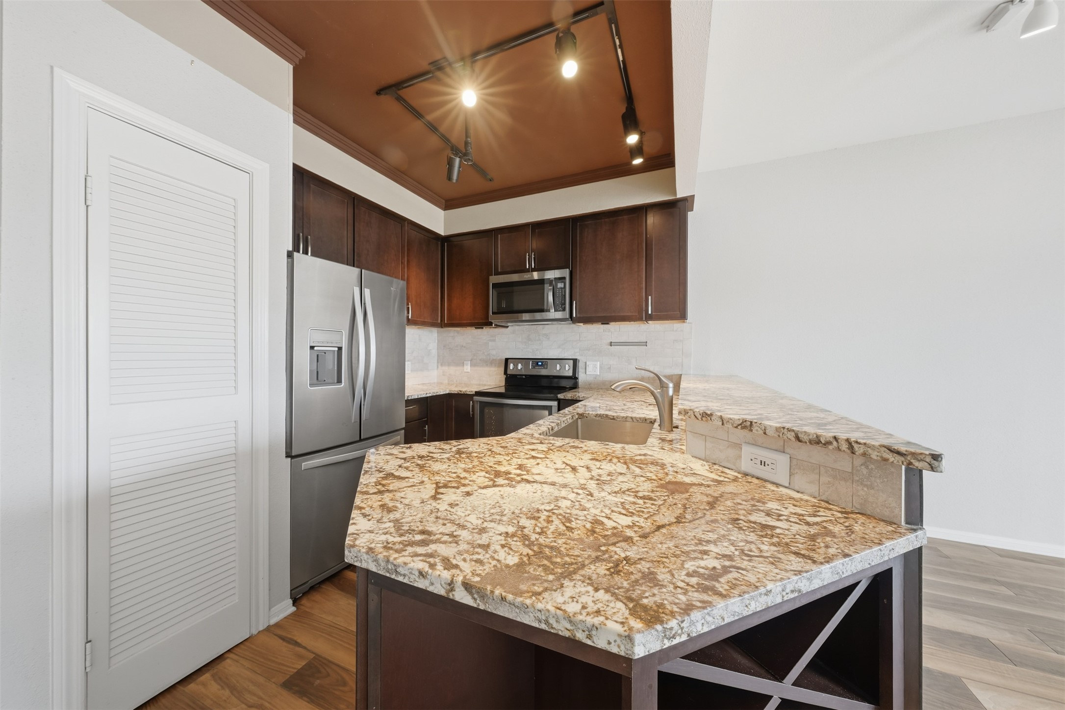 793 Davis Road, Unit 116 League City, TX 77573 - Photo 4 of 31 a kitchen with stainless steel appliances granite countertop a sink refrigerator and microwave
