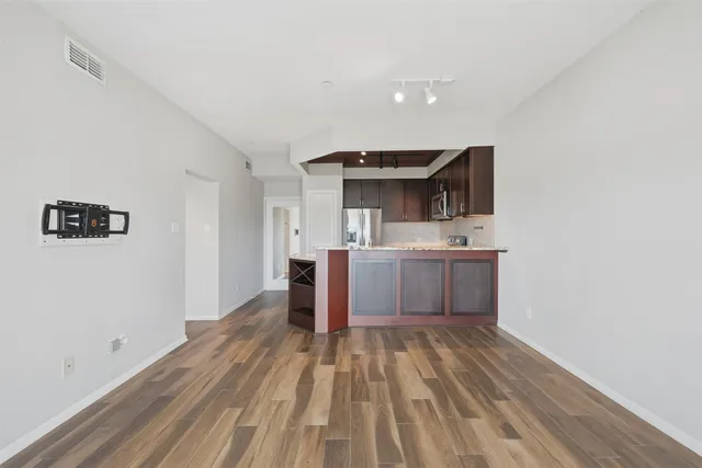 a view of kitchen with sink and wooden floor