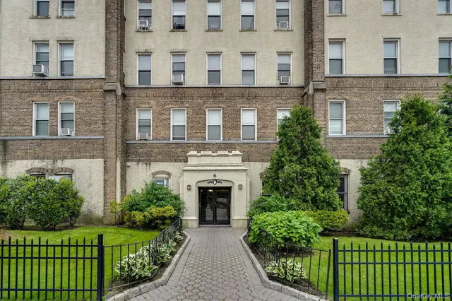 front view of a brick house with a yard