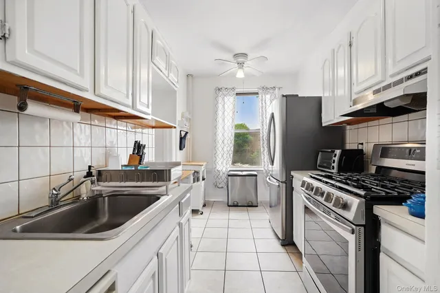 a kitchen with a sink a stove and refrigerator