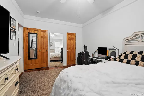 a bedroom with bed and large windows
