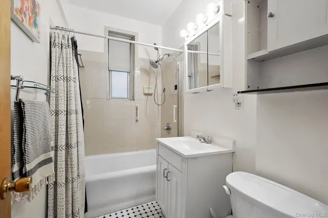 a bathroom with a shower a toilet and a sink