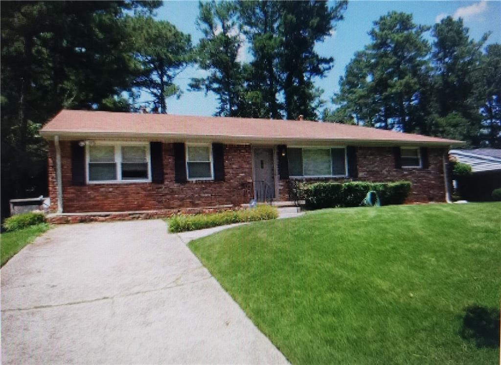 2825 Lancaster Drive East Point, GA 30344 - Photo 1 of 1 a front view of house with yard and green space
