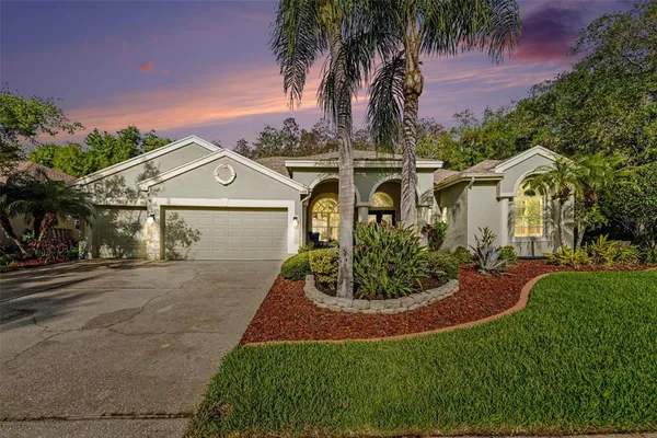 front view of house with a yard and potted plants