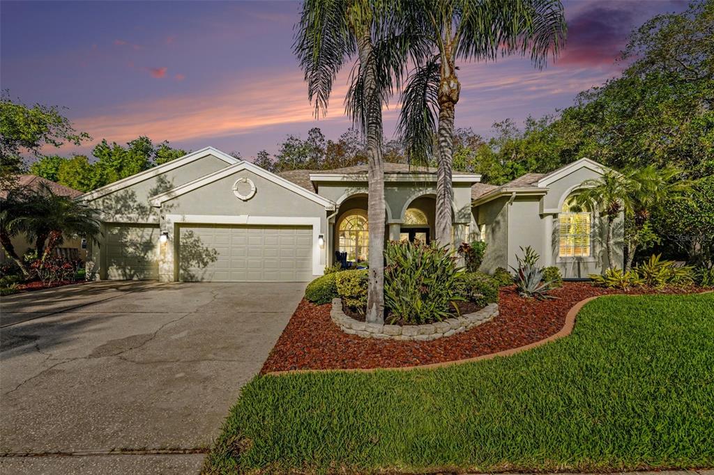 front view of house with a yard and potted plants