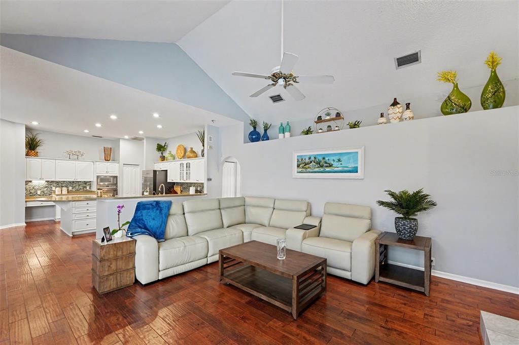 4491 Fallbrook Boulevard Palm Harbor, FL 34685 - Photo 17 of 46 a living room with furniture and a wooden floor