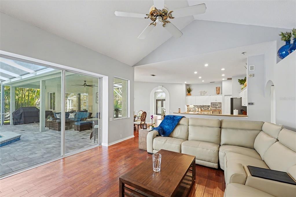 4491 Fallbrook Boulevard Palm Harbor, FL 34685 - Photo 19 of 46 a living room with furniture or kitchen view and a wooden floor