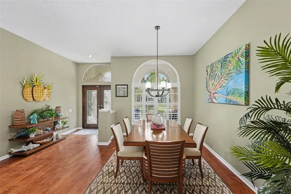 a view of a dining room with furniture wooden floor and chandelier