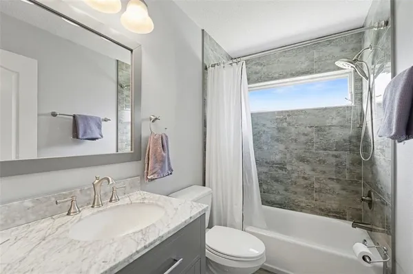 a view of a swimming pool with a sink and wooden fence