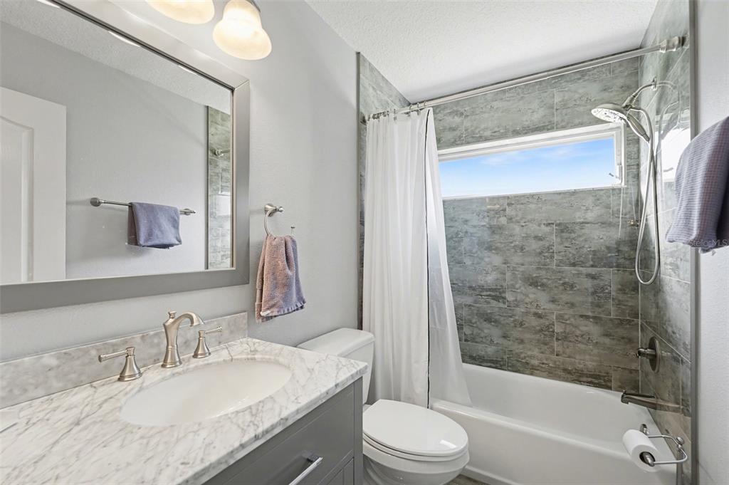 4491 Fallbrook Boulevard Palm Harbor, FL 34685 - Photo 22 of 46 a bathroom with a granite countertop sink toilet and shower