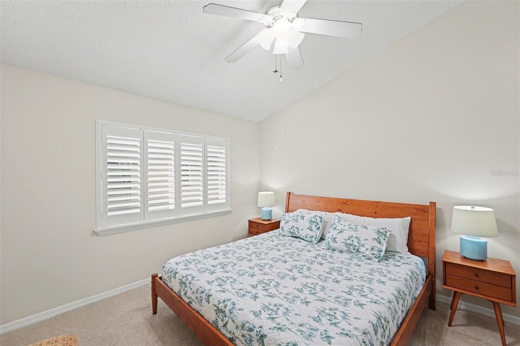 4491 Fallbrook Boulevard Palm Harbor, FL 34685 - Photo 23 of 46 a bedroom with a bed and a chandelier