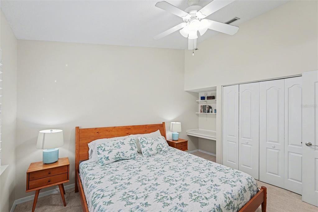4491 Fallbrook Boulevard Palm Harbor, FL 34685 - Photo 24 of 46 a bedroom with a bed and a chandelier