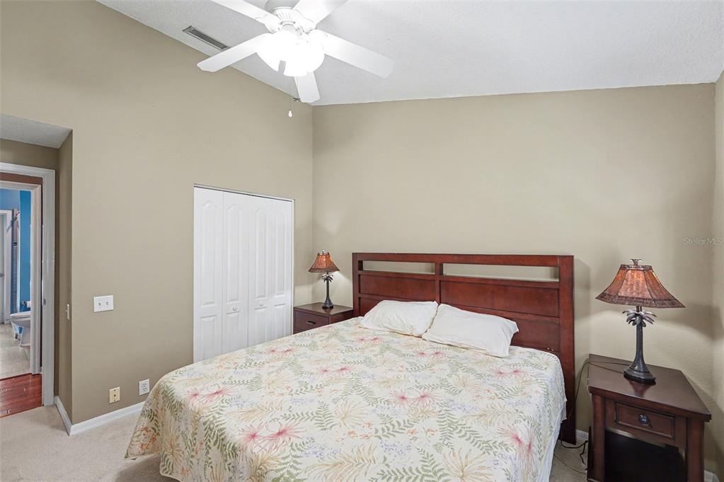 4491 Fallbrook Boulevard Palm Harbor, FL 34685 - Photo 25 of 46 a bedroom with a bed and a chandelier