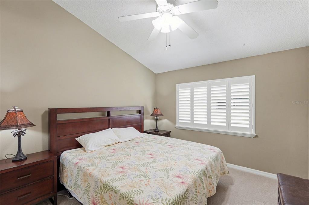 4491 Fallbrook Boulevard Palm Harbor, FL 34685 - Photo 26 of 46 a bedroom with a bed and a chandelier