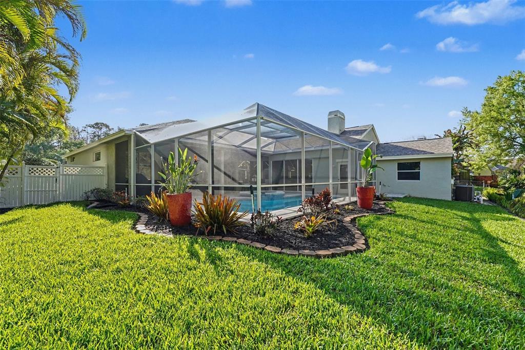 4491 Fallbrook Boulevard Palm Harbor, FL 34685 - Photo 31 of 46 a view of a house with backyard and garden