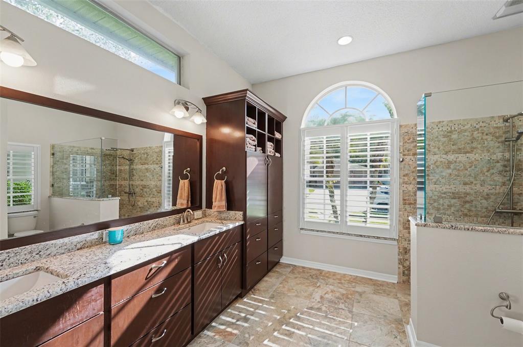 4491 Fallbrook Boulevard Palm Harbor, FL 34685 - Photo 10 of 46 a bathroom with a granite countertop sink mirror and a large window