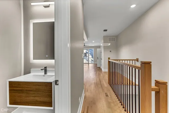 a view of a hallway with wooden floor and entryway