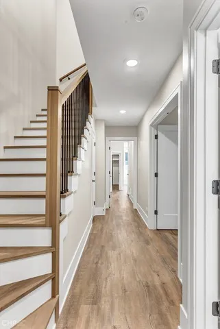 a view of a room with wooden floor and a ceiling fan