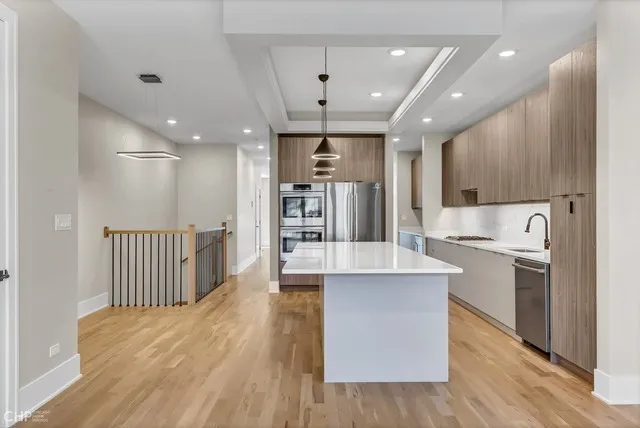 a view of empty room with wooden floor and fireplace