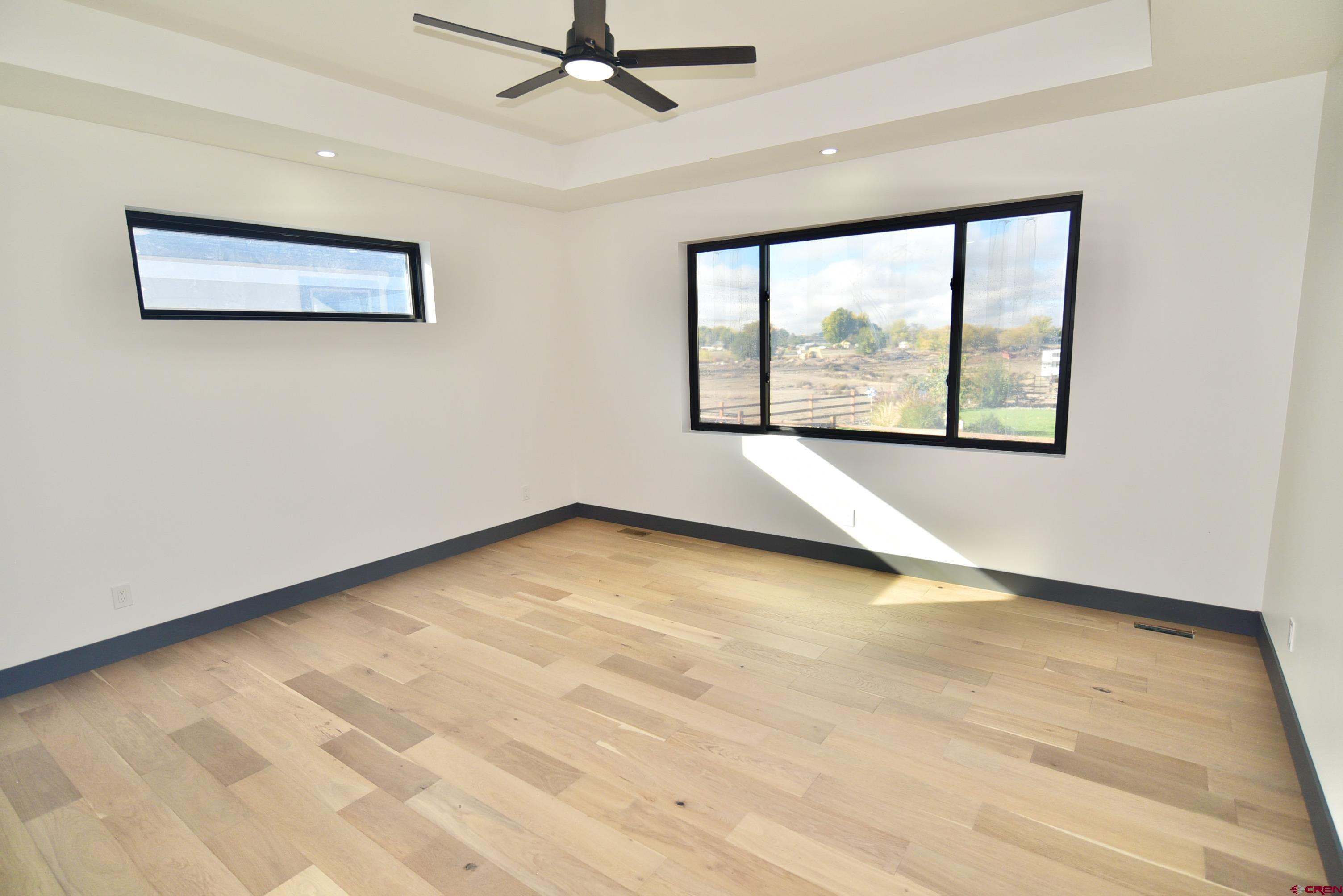 1508 Criterion Street Delta, CO 81416 - Photo 13 of 27 a view of an empty room with a window and a ceiling fan