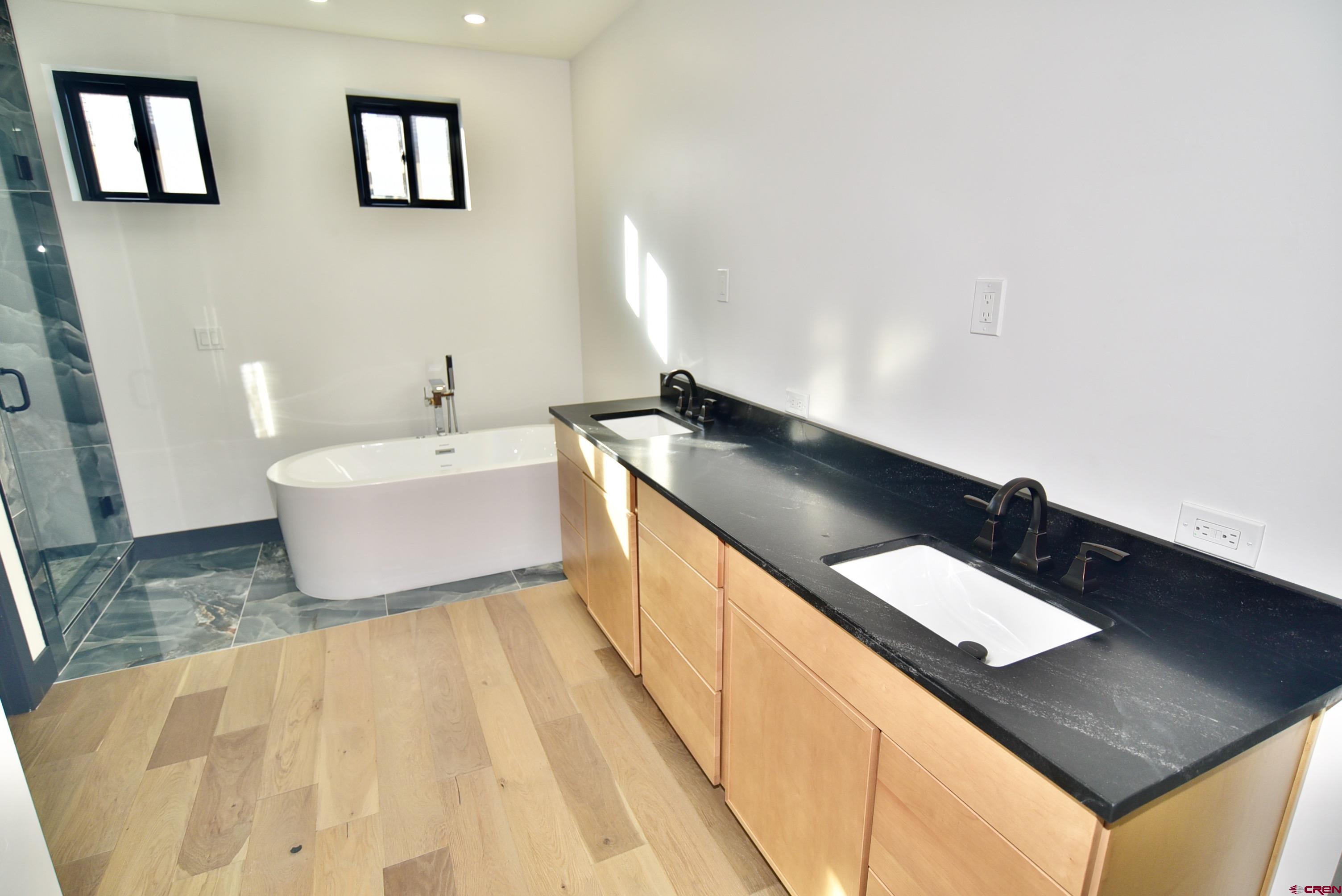 1508 Criterion Street Delta, CO 81416 - Photo 14 of 27 a spacious bathroom with a double vanity sink and a mirror