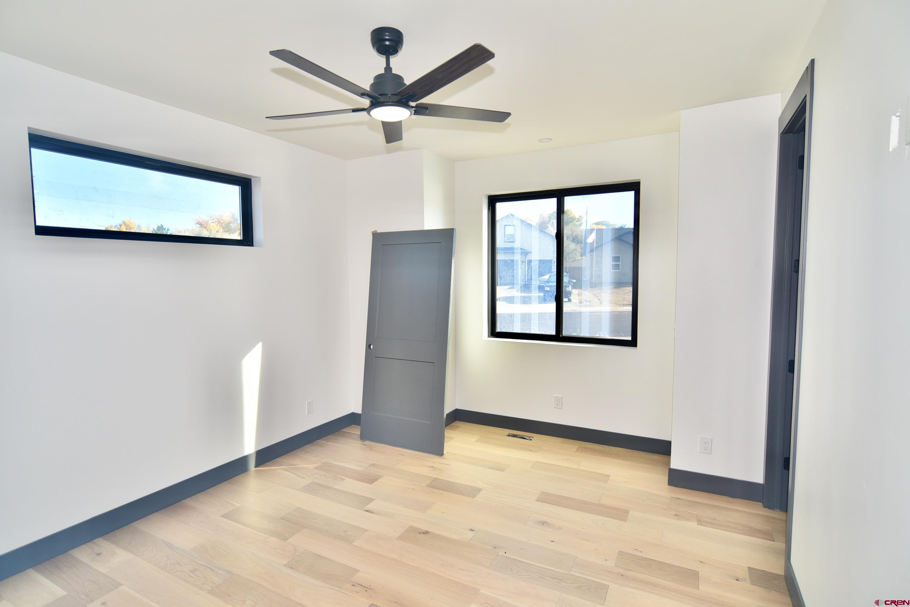 1508 Criterion Street Delta, CO 81416 - Photo 20 of 27 a view of an empty room with wooden floor and a window
