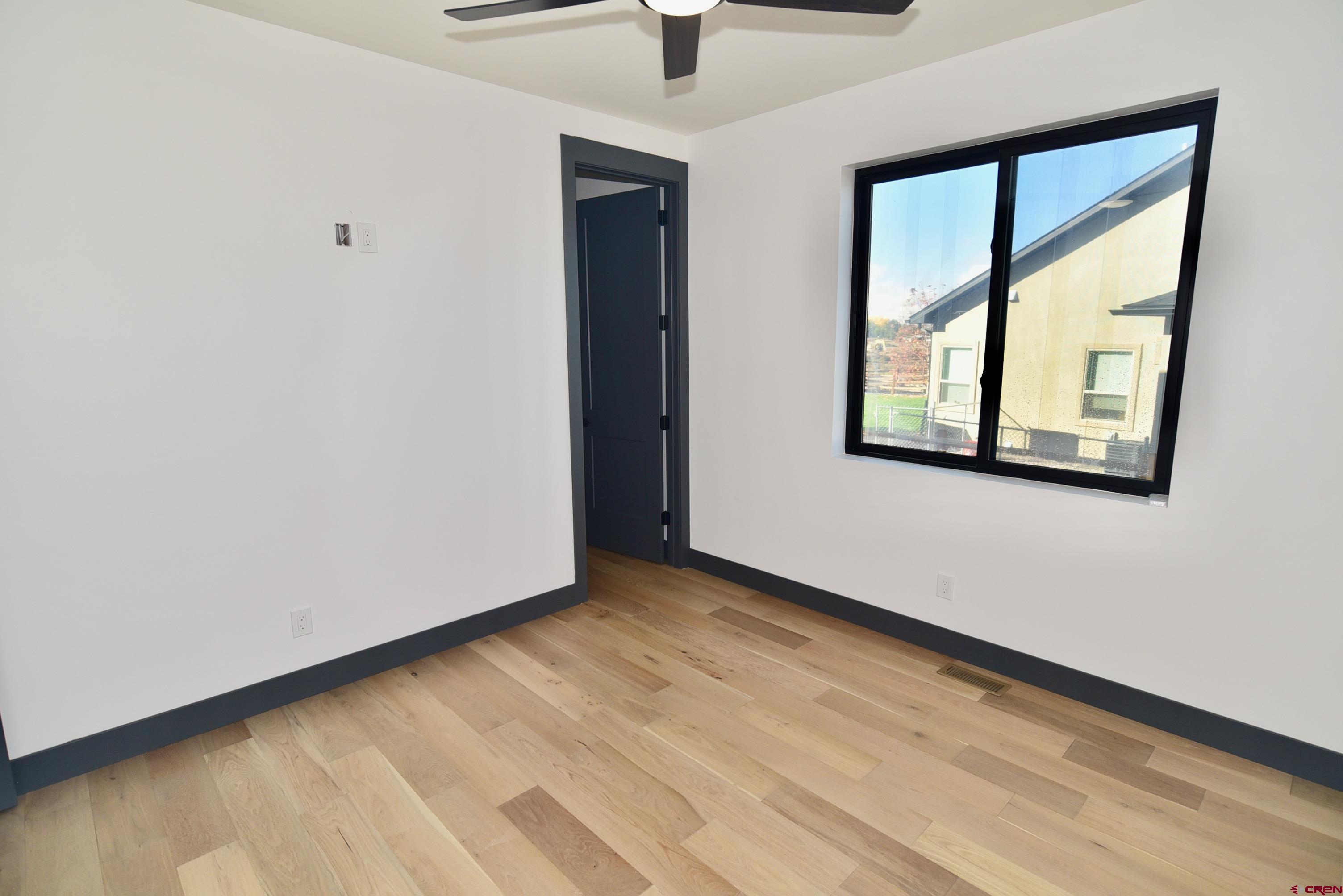 1508 Criterion Street Delta, CO 81416 - Photo 22 of 27 a view of an empty room with window and wooden floor