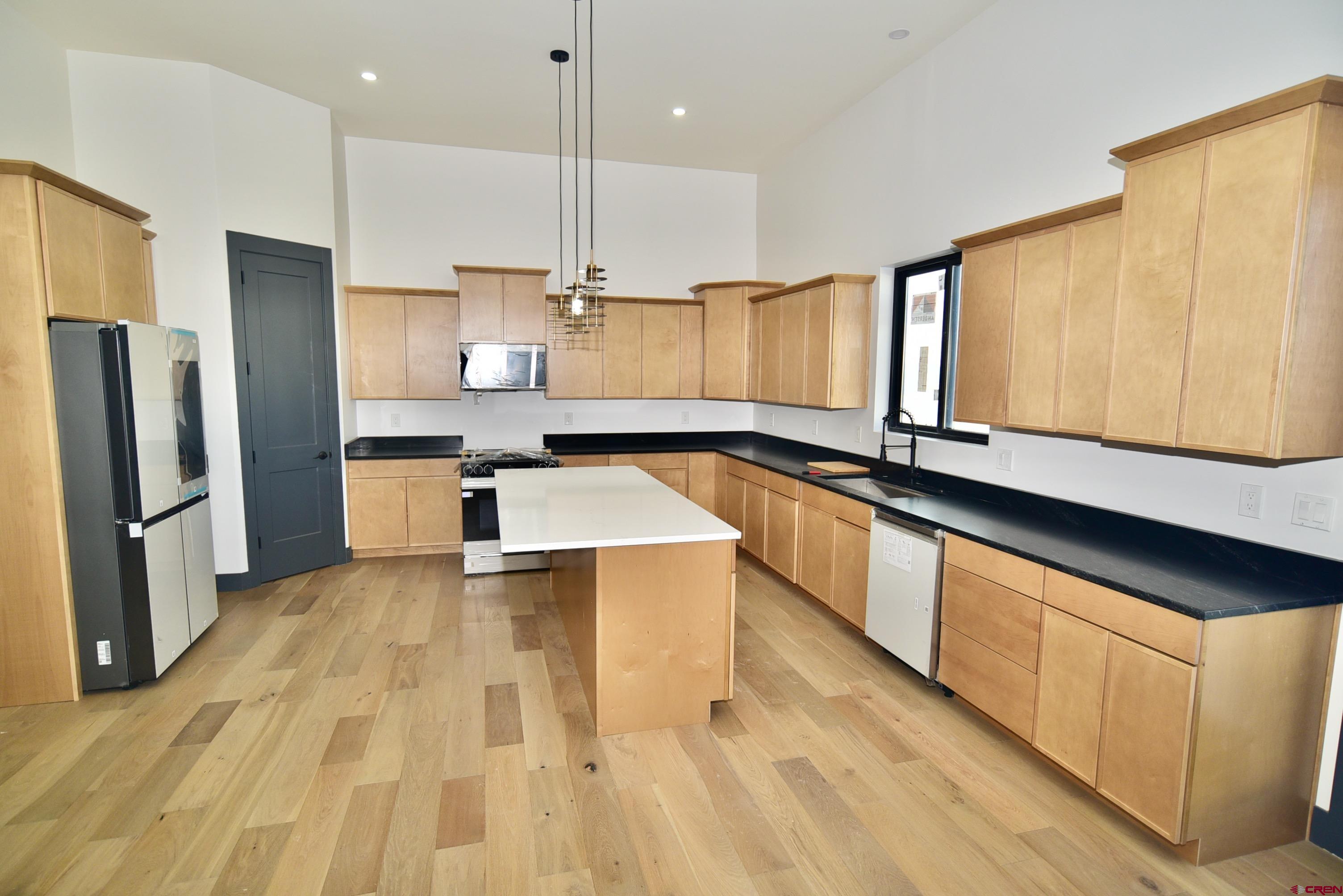1508 Criterion Street Delta, CO 81416 - Photo 4 of 27 a large kitchen with a large counter top stainless steel appliances and cabinets
