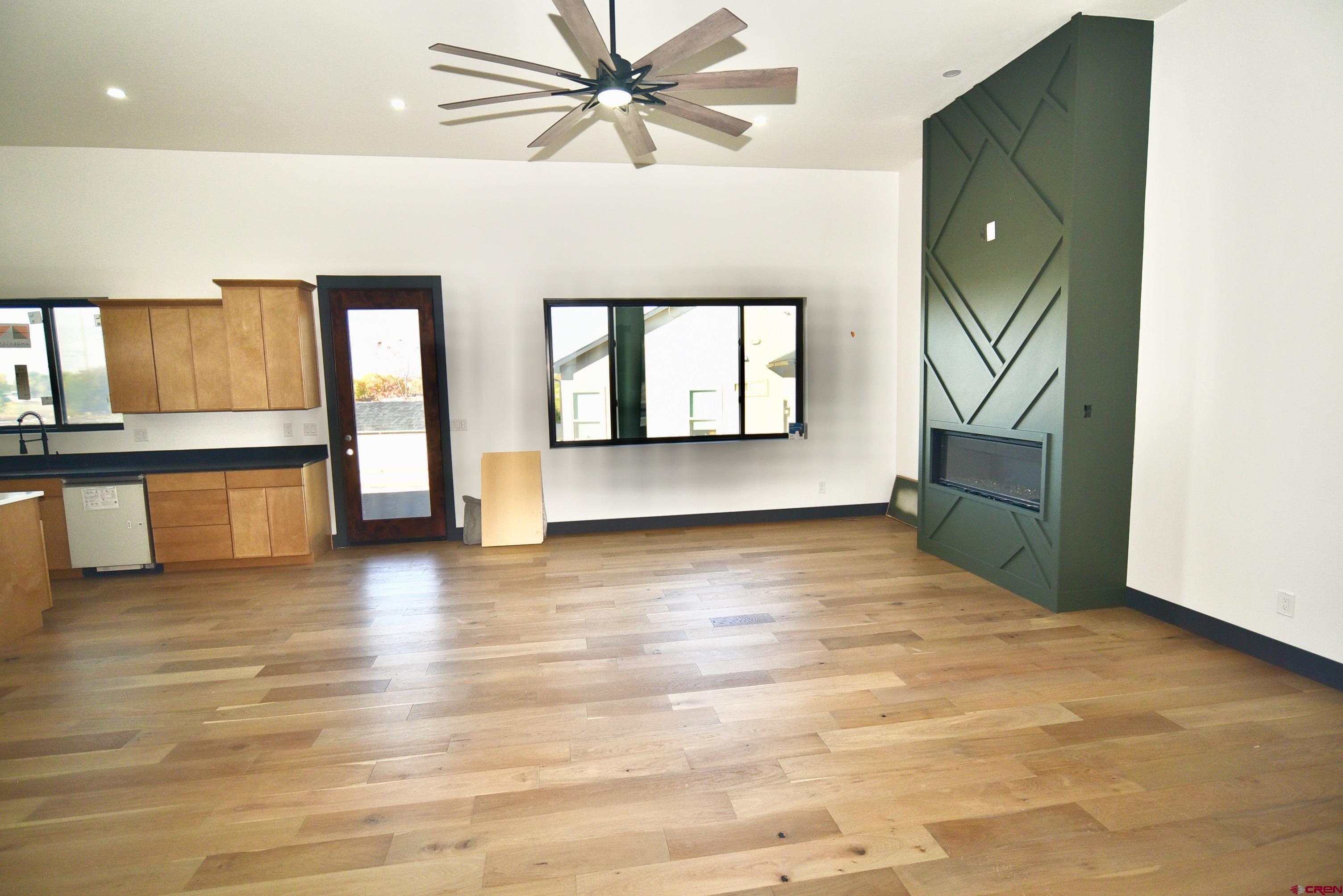 1508 Criterion Street Delta, CO 81416 - Photo 6 of 27 a view of an empty room with a window and wooden floor