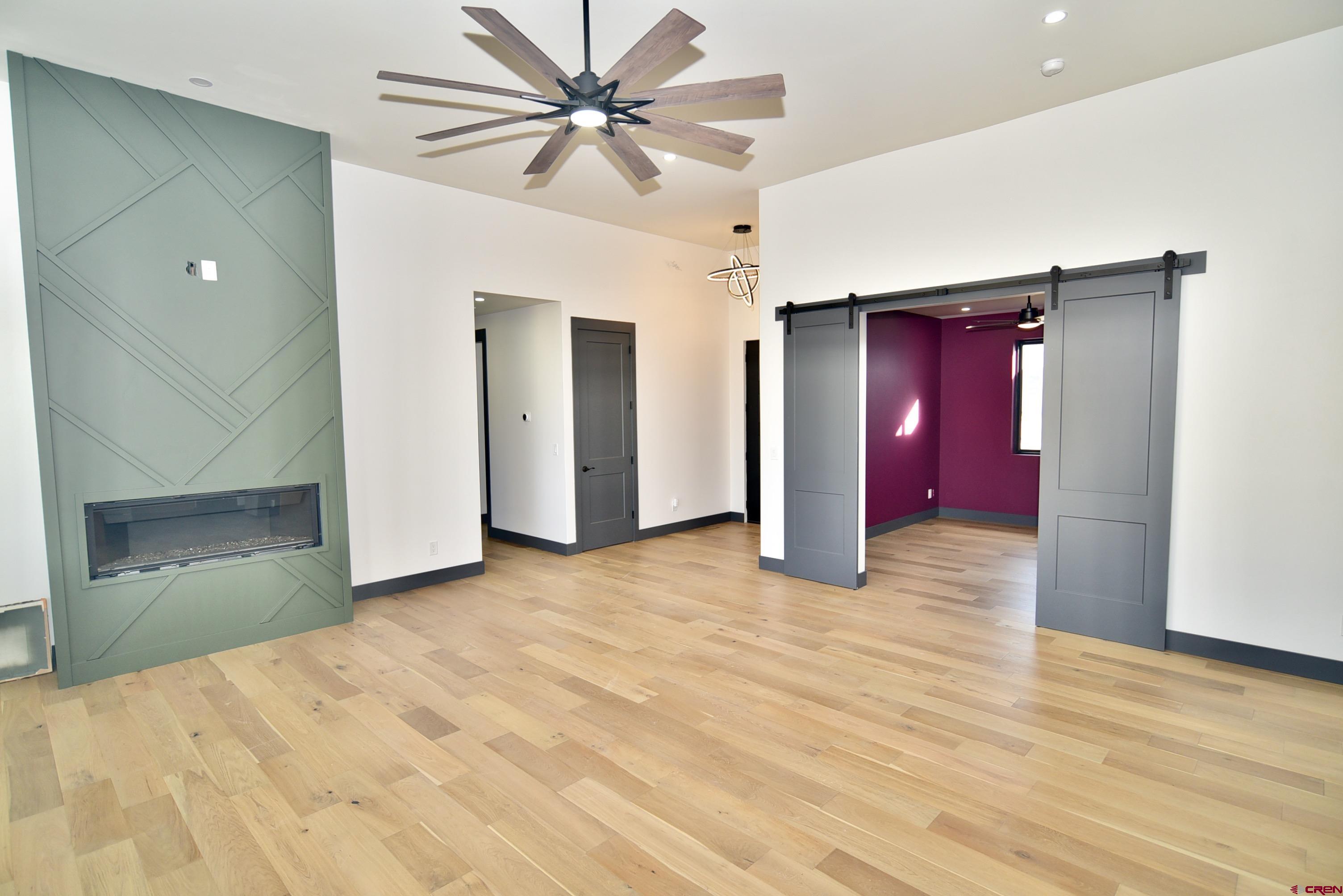 1508 Criterion Street Delta, CO 81416 - Photo 10 of 27 a view of empty room with wooden floor and ceiling fan