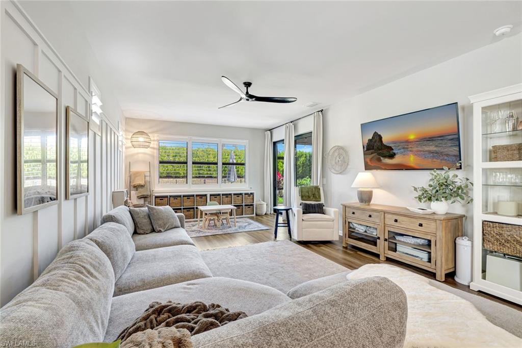 2240 Yellowfin Circle Naples, FL 34114 - Photo 9 of 38 Living room with ceiling fan and luxury vinyl flooring